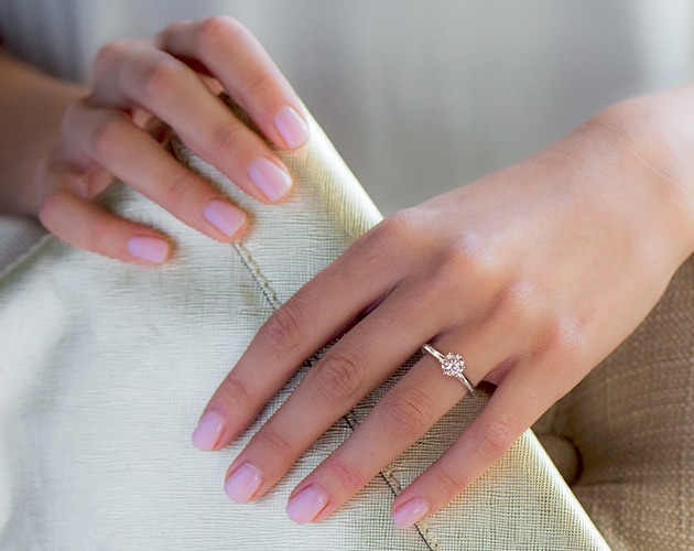 4.26 carat solitaire engagement ring on a woman's finger