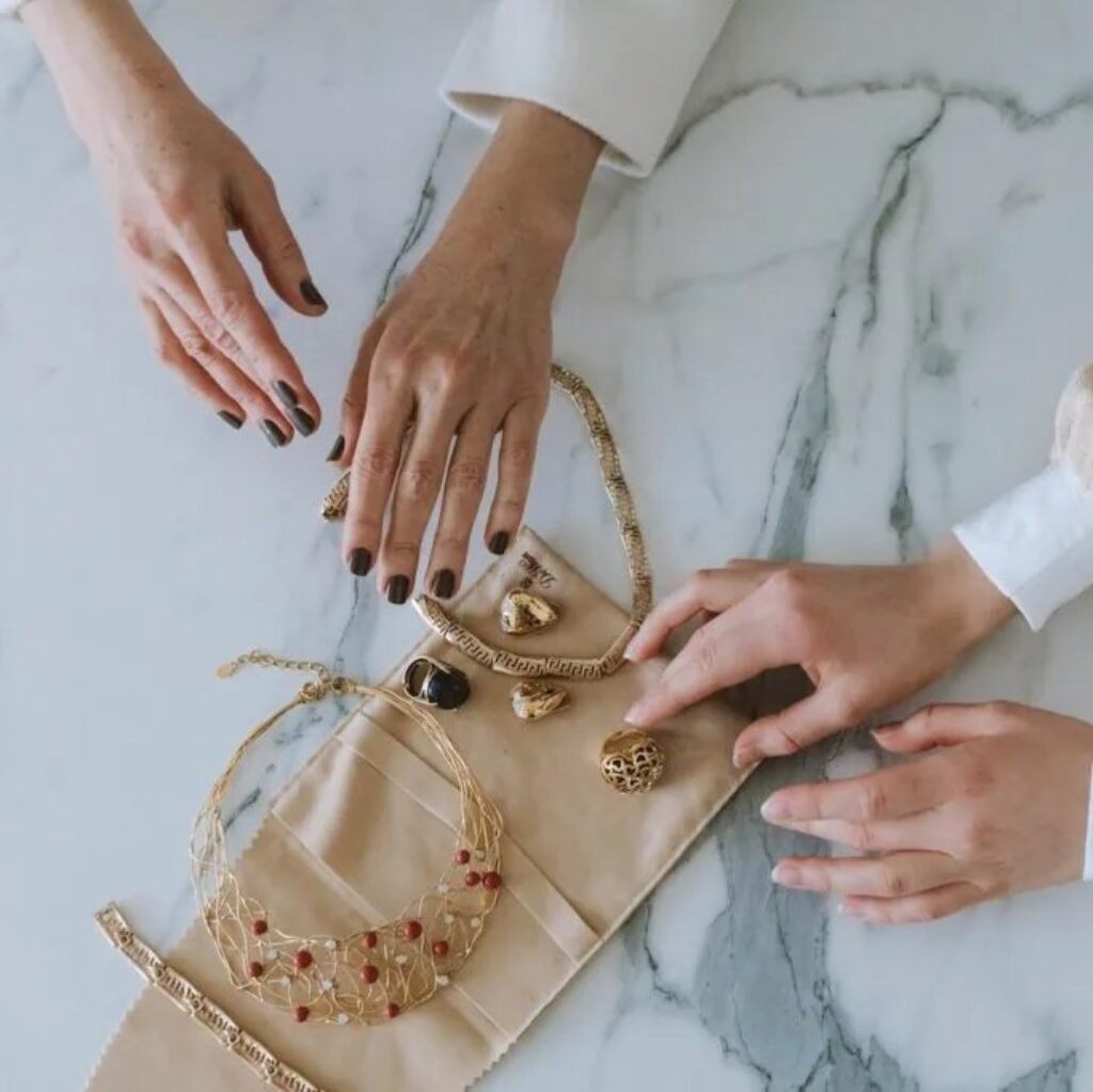 hands holding jewelry