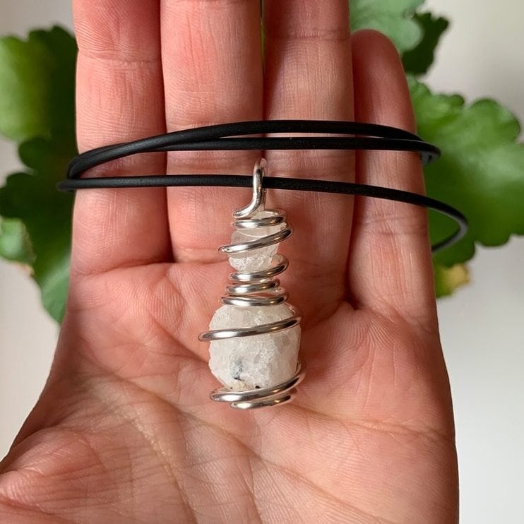 a hand with analcime pendant