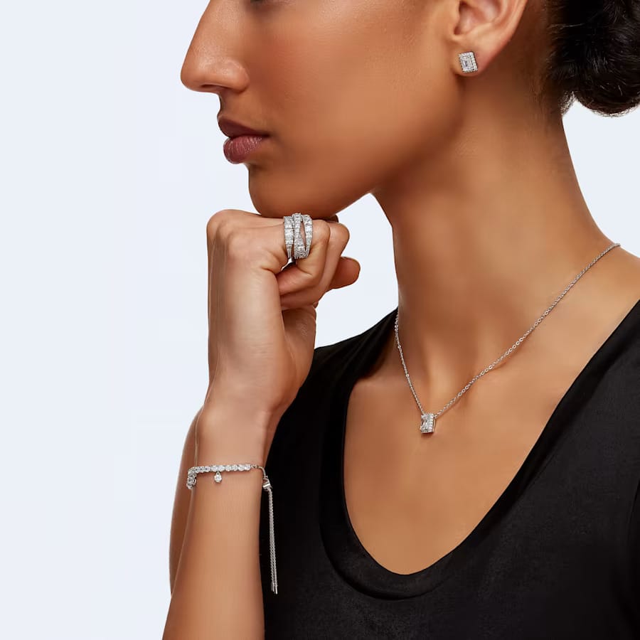 a woman wearing swarovski jewelry set