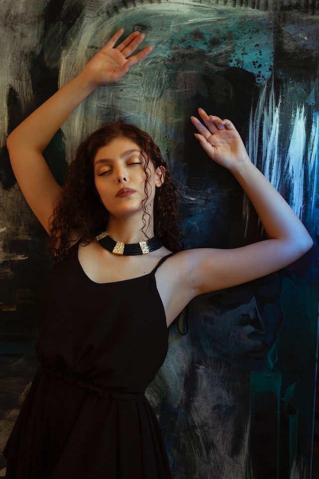 girl with black dress and statement necklace
