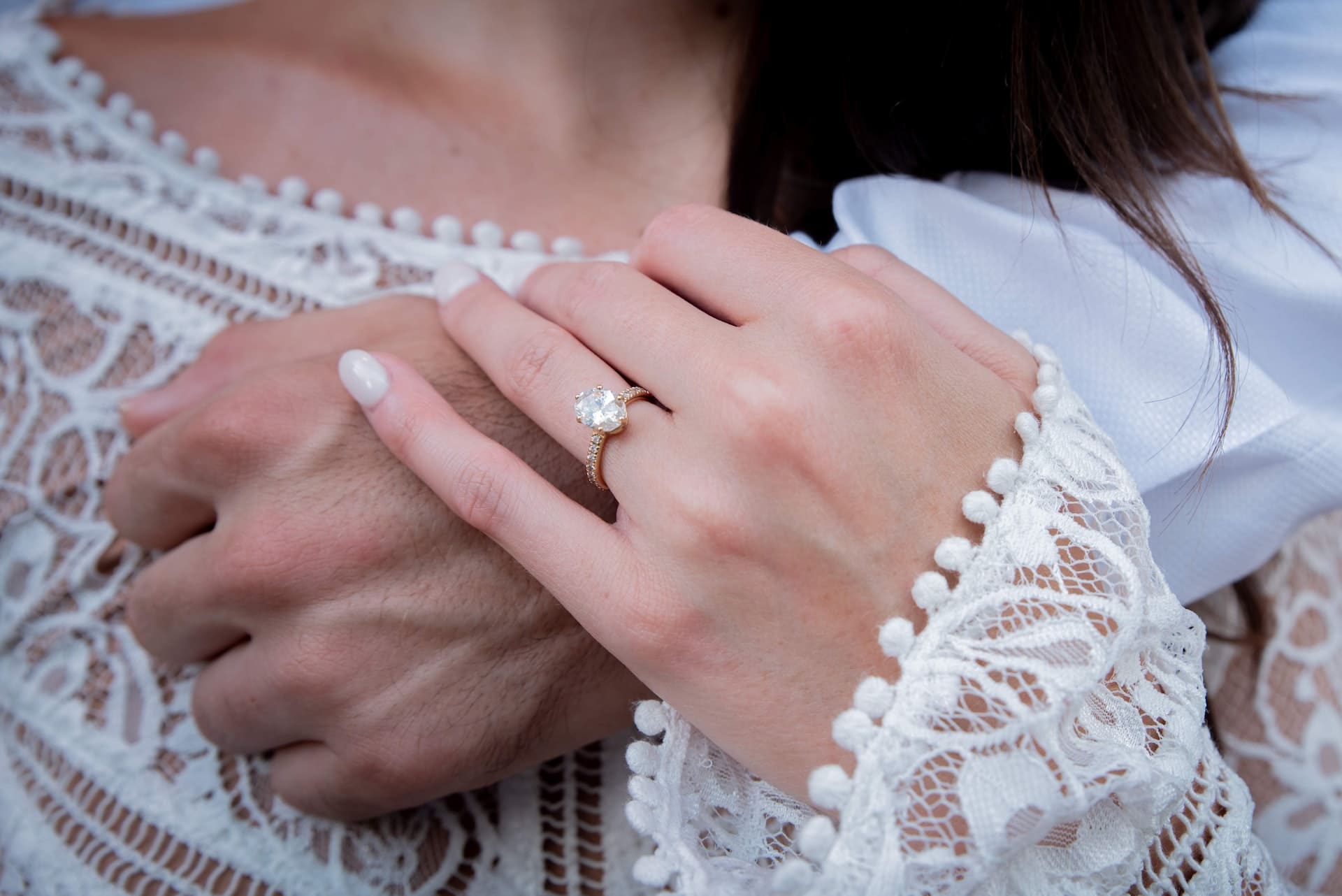 woman with ring holding mans hand