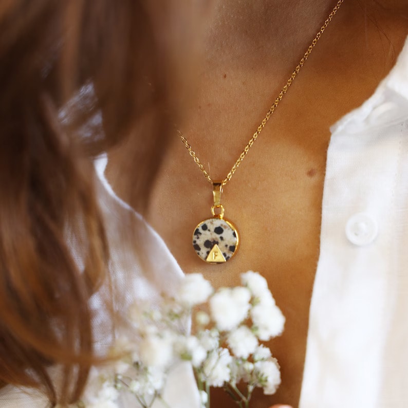 dalmatian jasper necklace on the woman's neck