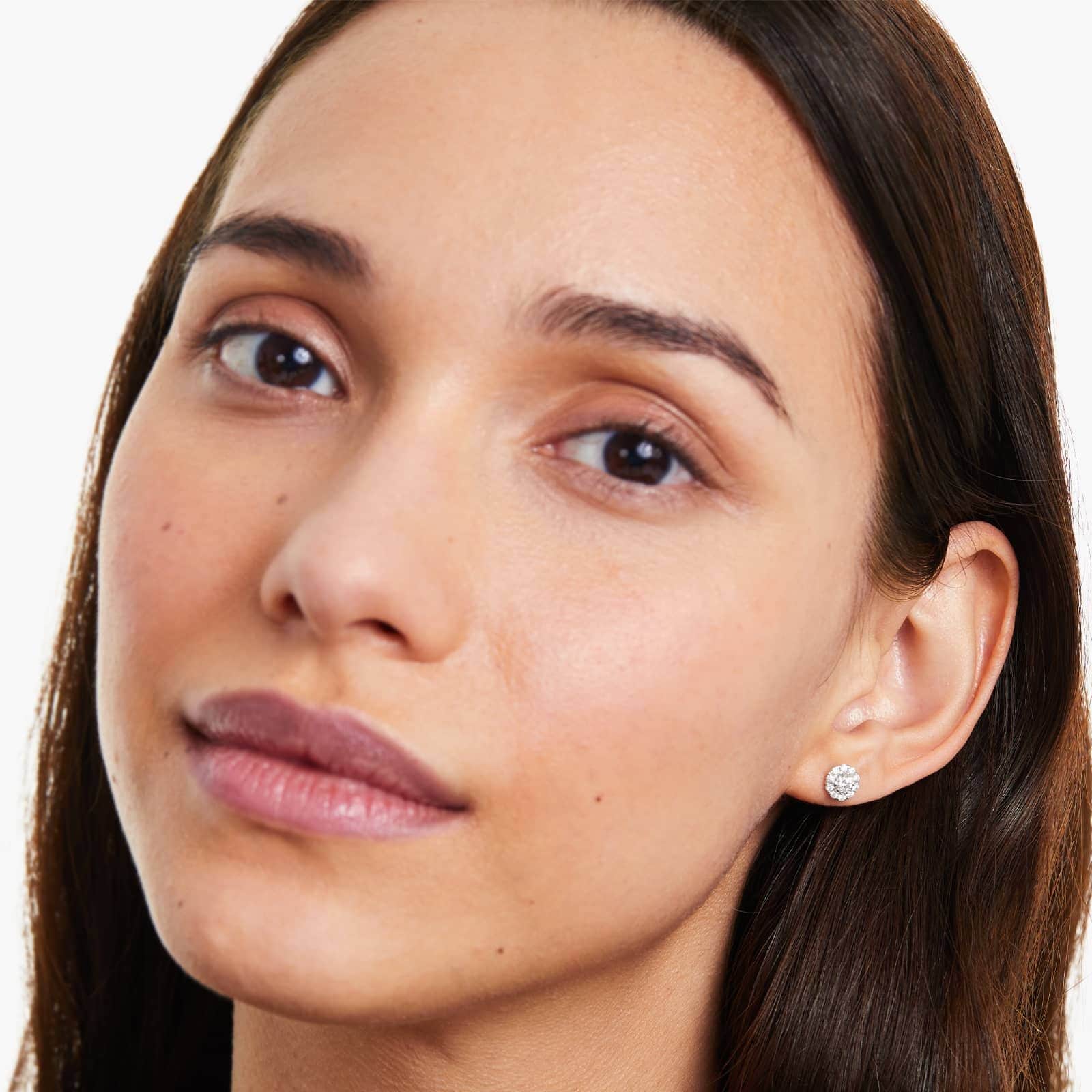 girl wearing diamond halo stud earrings