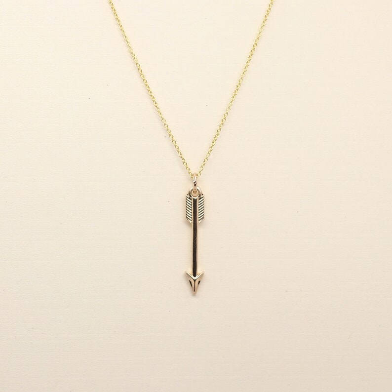 Gold arrow pendant