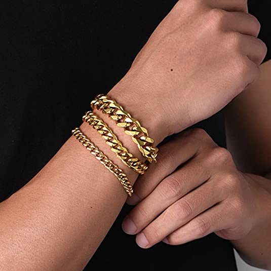 a man wearing gold chain bracelets