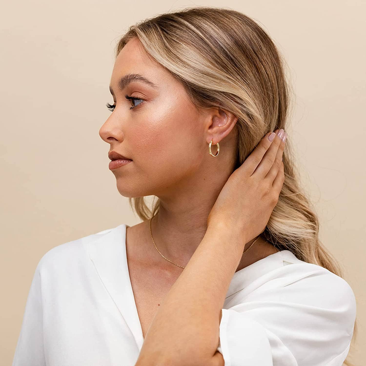 woman wearing gold hoops