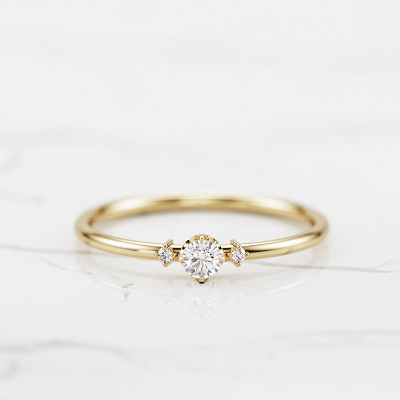Minimalist three stone engagement ring