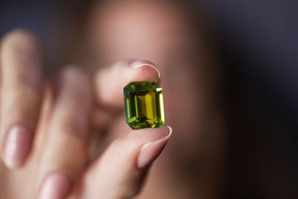 girl holding peridot gemstone