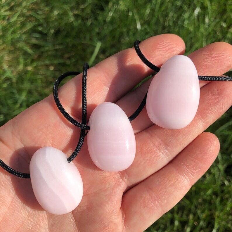 holding pink calcite necklaces