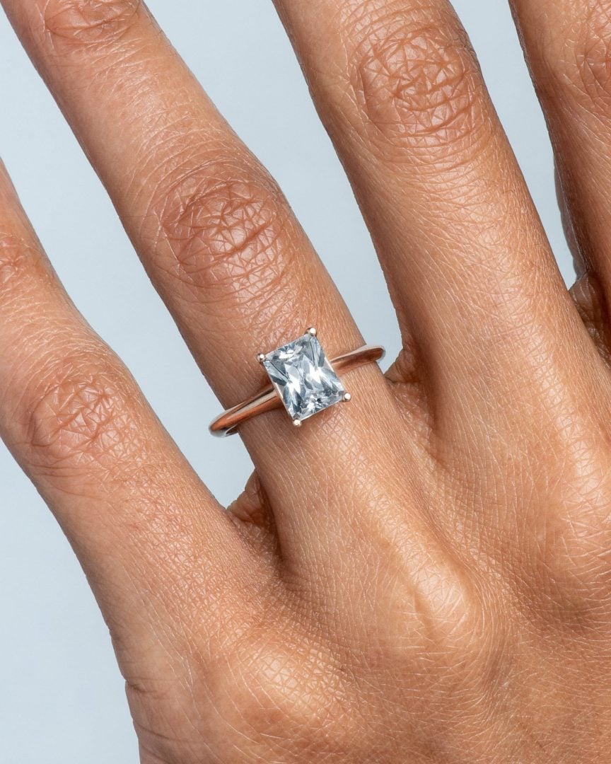 radiant cut diamond engagement ring on the ring finger