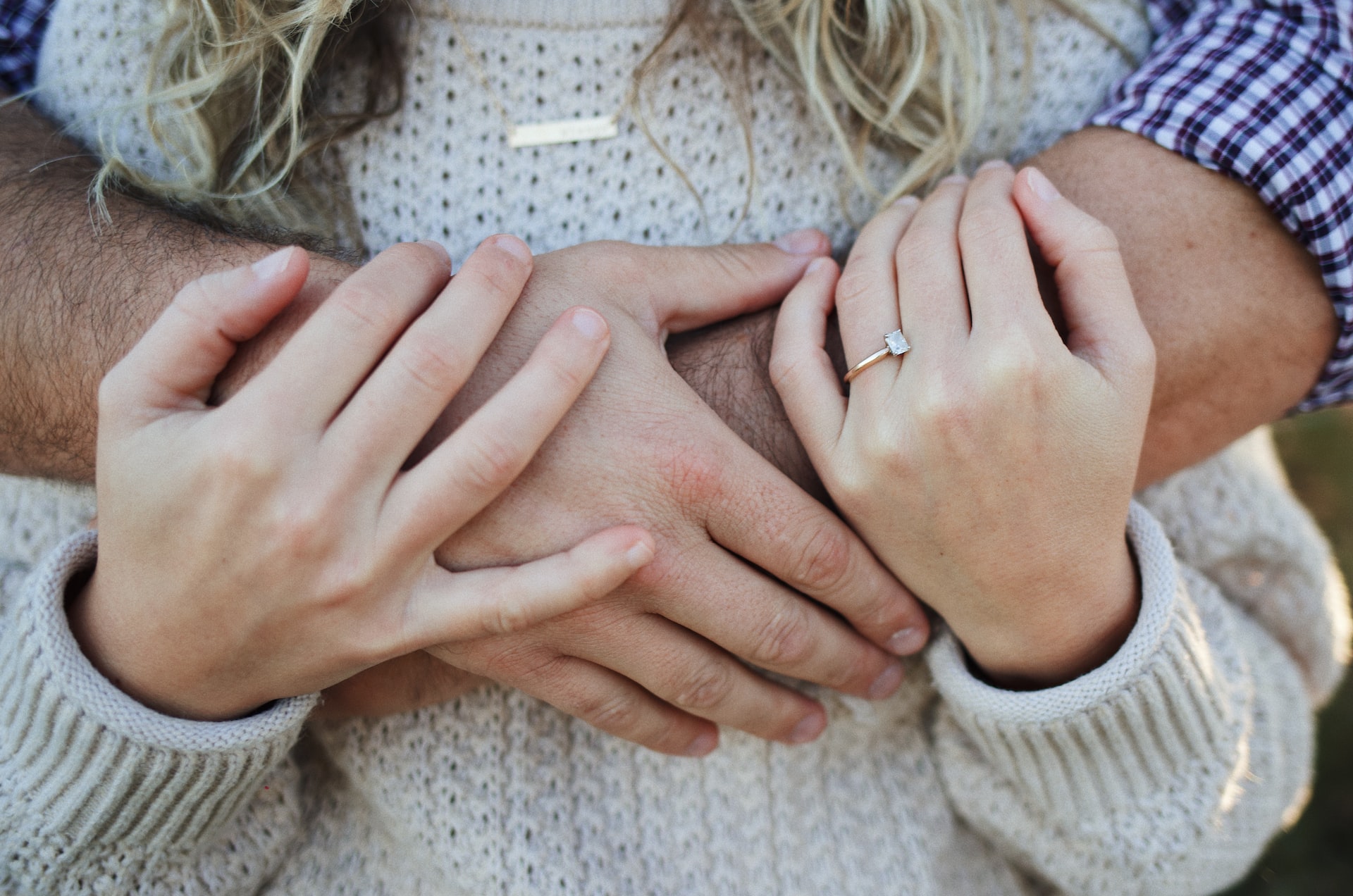girl and boy hands with radiant cut diamond on finger