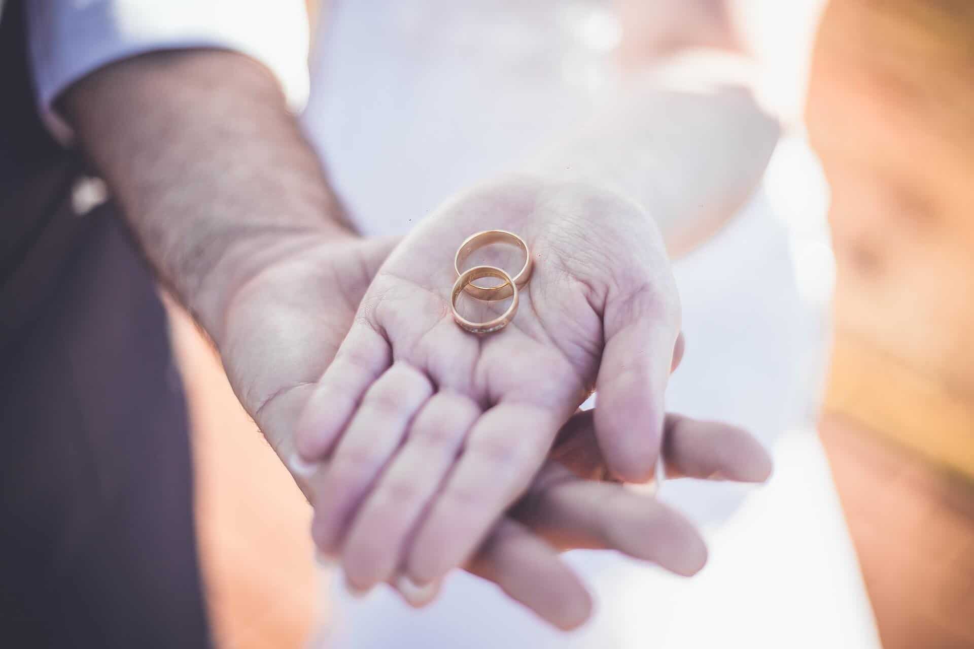 woman holding engagement rings
