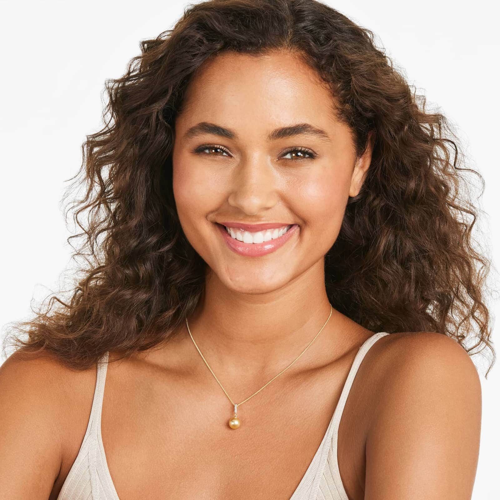 a woman wearing south sea pearl and diamond pendant necklace