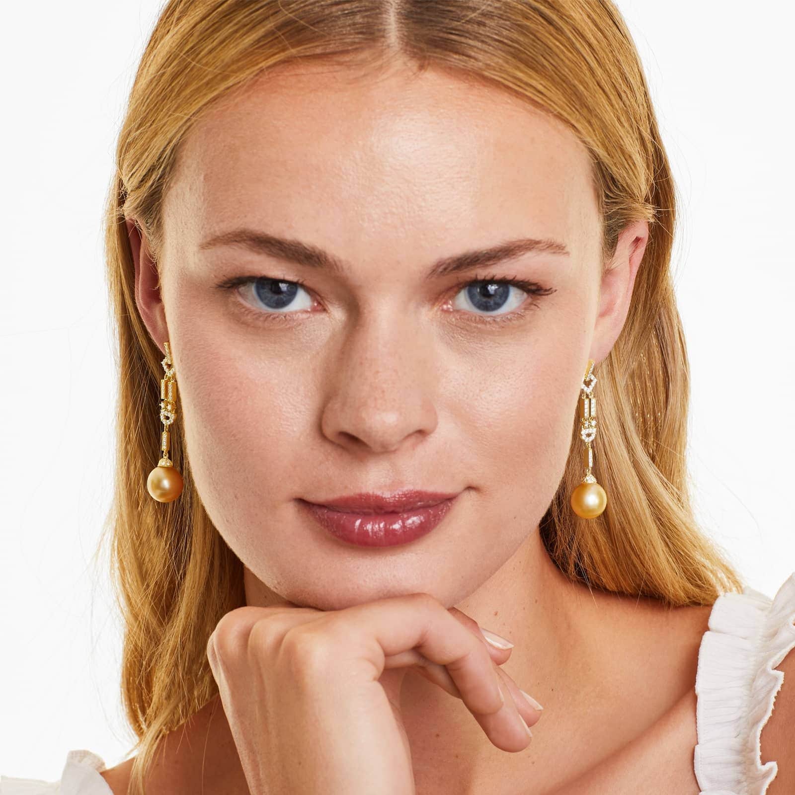 a woman wearing south sea pearl art deco earrings