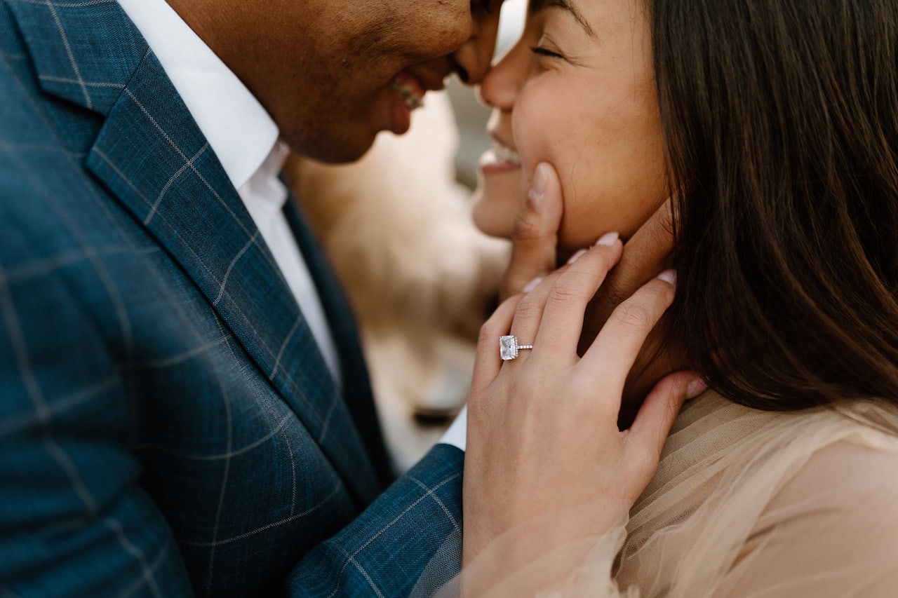 couple with woman wearing engagement ring
