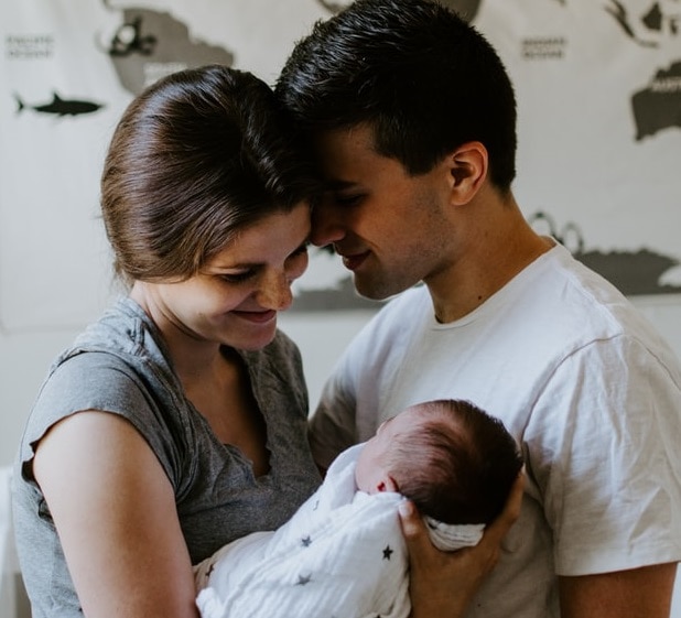Couple with new born baby, dad thinking of giving push gift