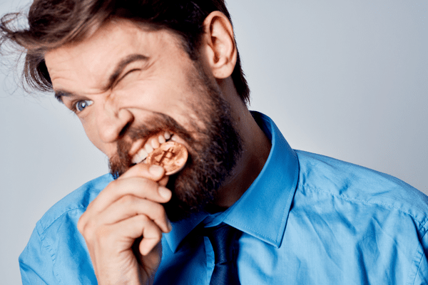 biting gold coin