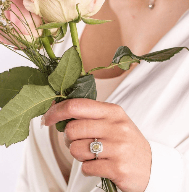 diamond halo engagement ring on the woman's ring