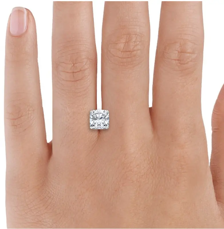 2.5 carat cushion loose diamond between fingers