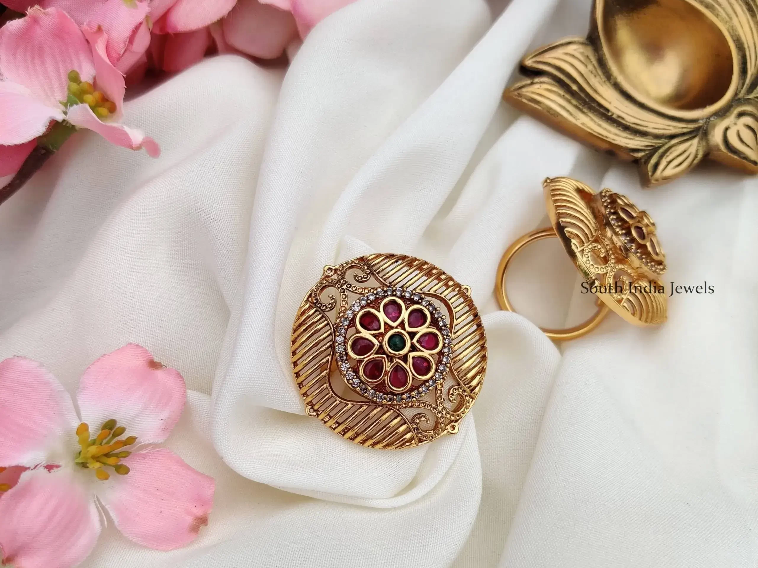 adjustable finger gold ring on white fabric with pink flowers