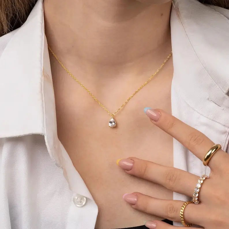 cubic zirconia teardrop necklace on the woman's neck