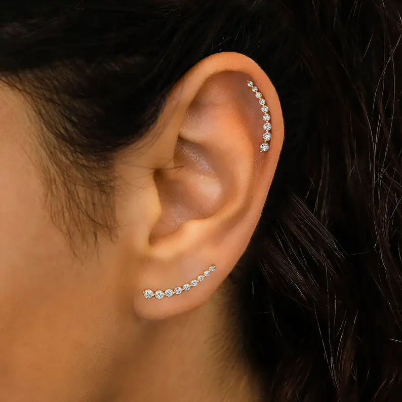 a woman wearing diamond curved bar ear climbers crawlers
