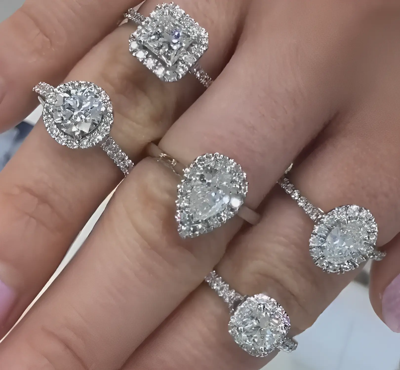 diamond halo engagement rings on fingers