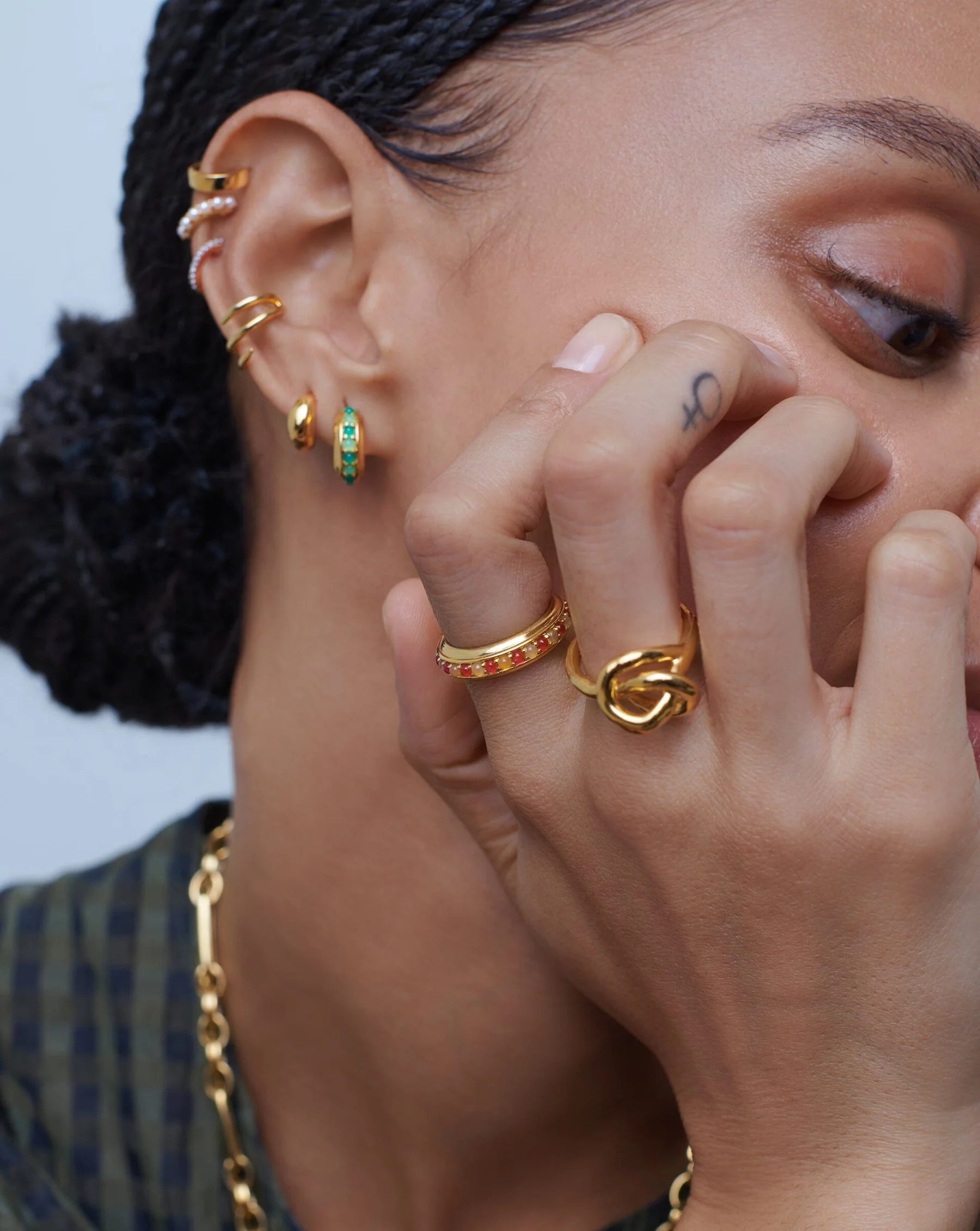 a woman wearing missoma gold jewelry