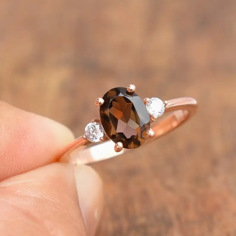 holding a natural smoky quartz ring