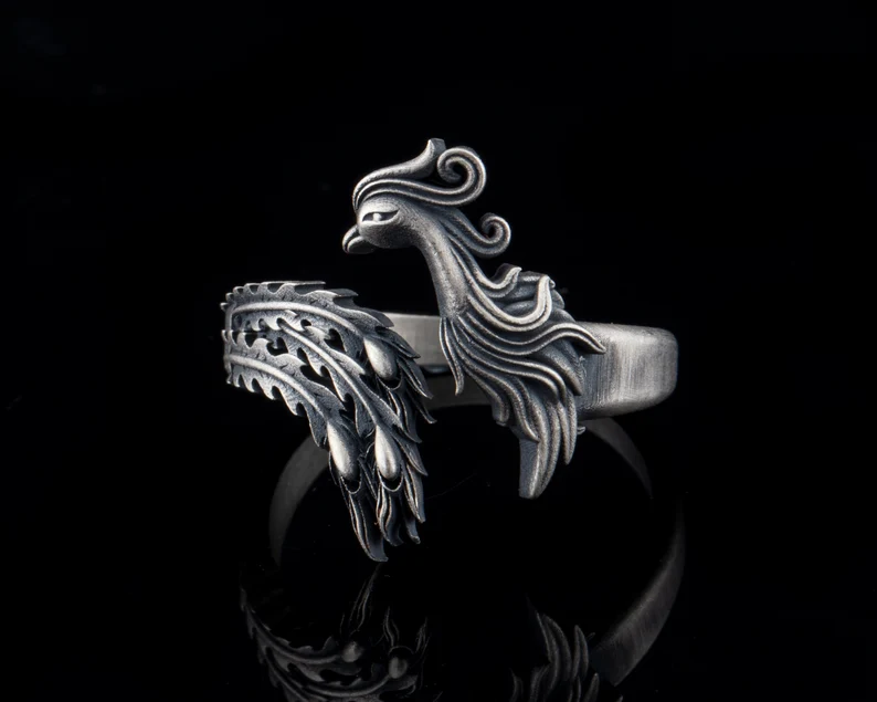 phoneix silver ring on black background