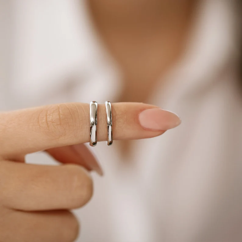platinum dome wedding bands in pointing finger