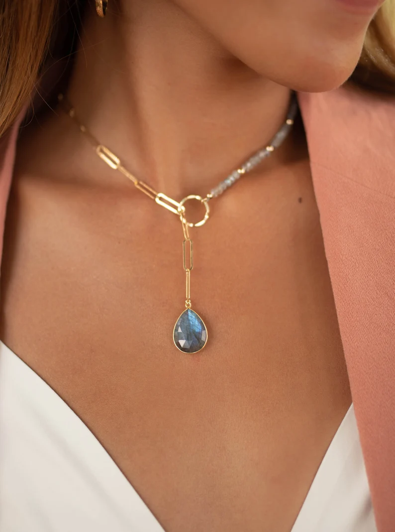 rainbow labradorite tear drop lariat on the woman's neck