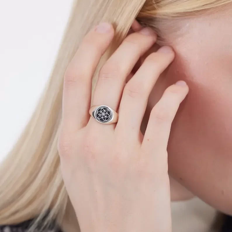 a woman wearing a seed of life ring