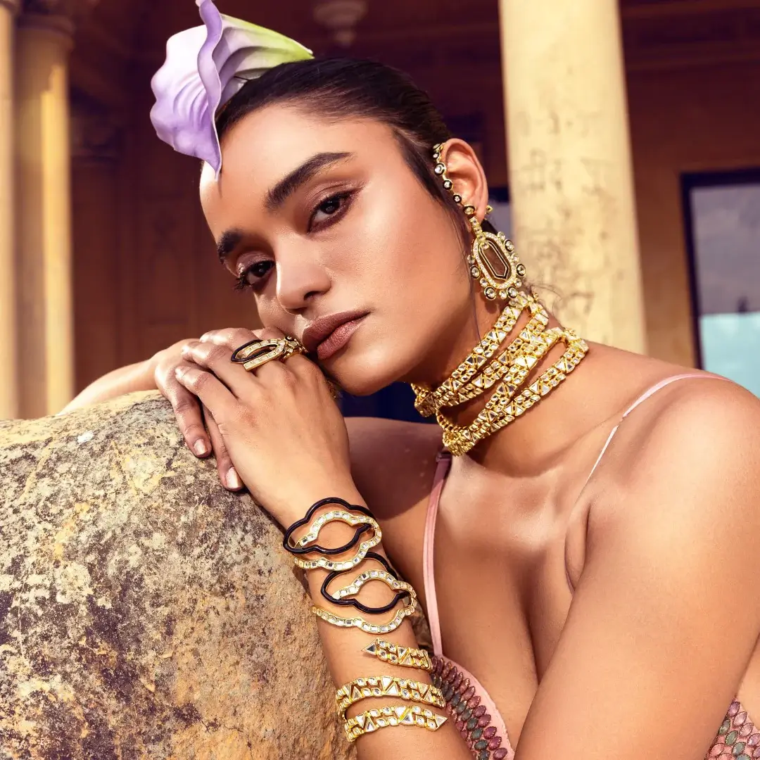 an indian woman wearing gold serpent cuff and jewelry