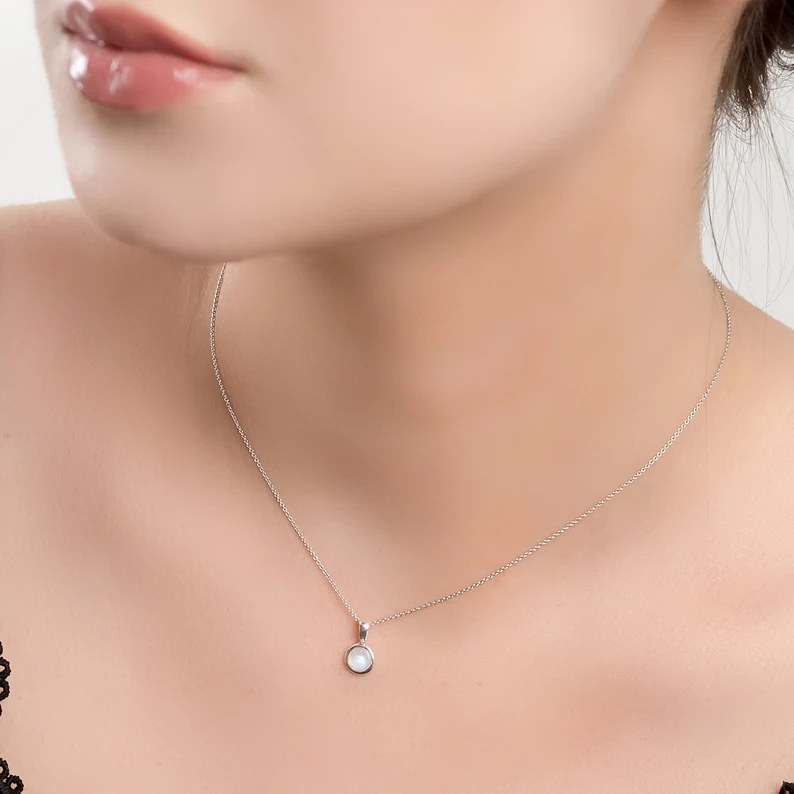 sterling silver moonstone necklace on the woman's neck